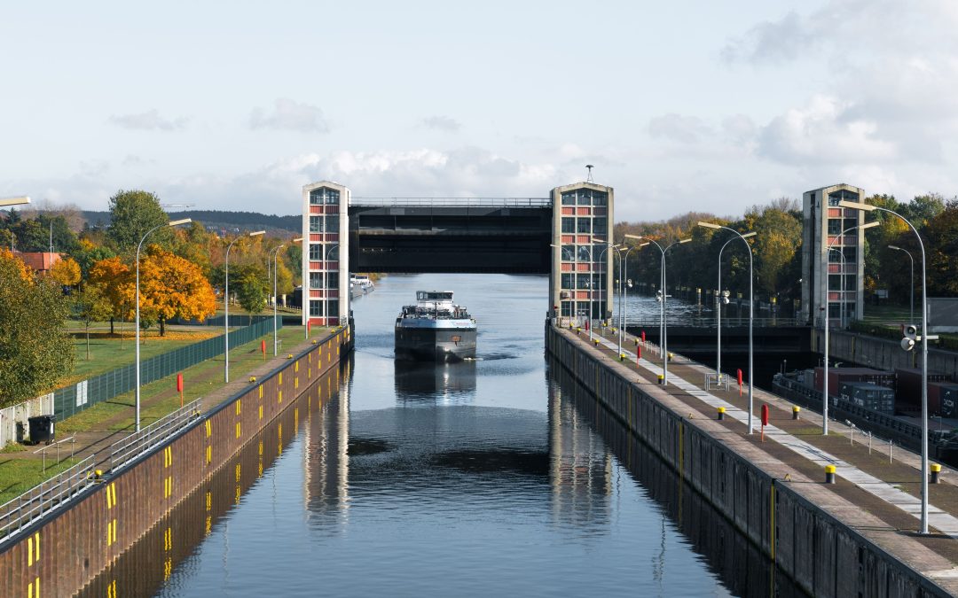Binnenvaartschip op een waterweg bij een industriële omgeving